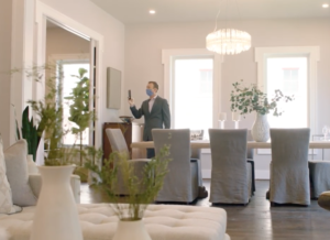 man taking photo of room in a home