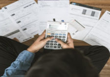 Top view man sitting on the floor stressed and confused by calculate expense from invoice or bill, have no money to pay thinking of taking the house to mortgage causing debt, bankruptcy concept.